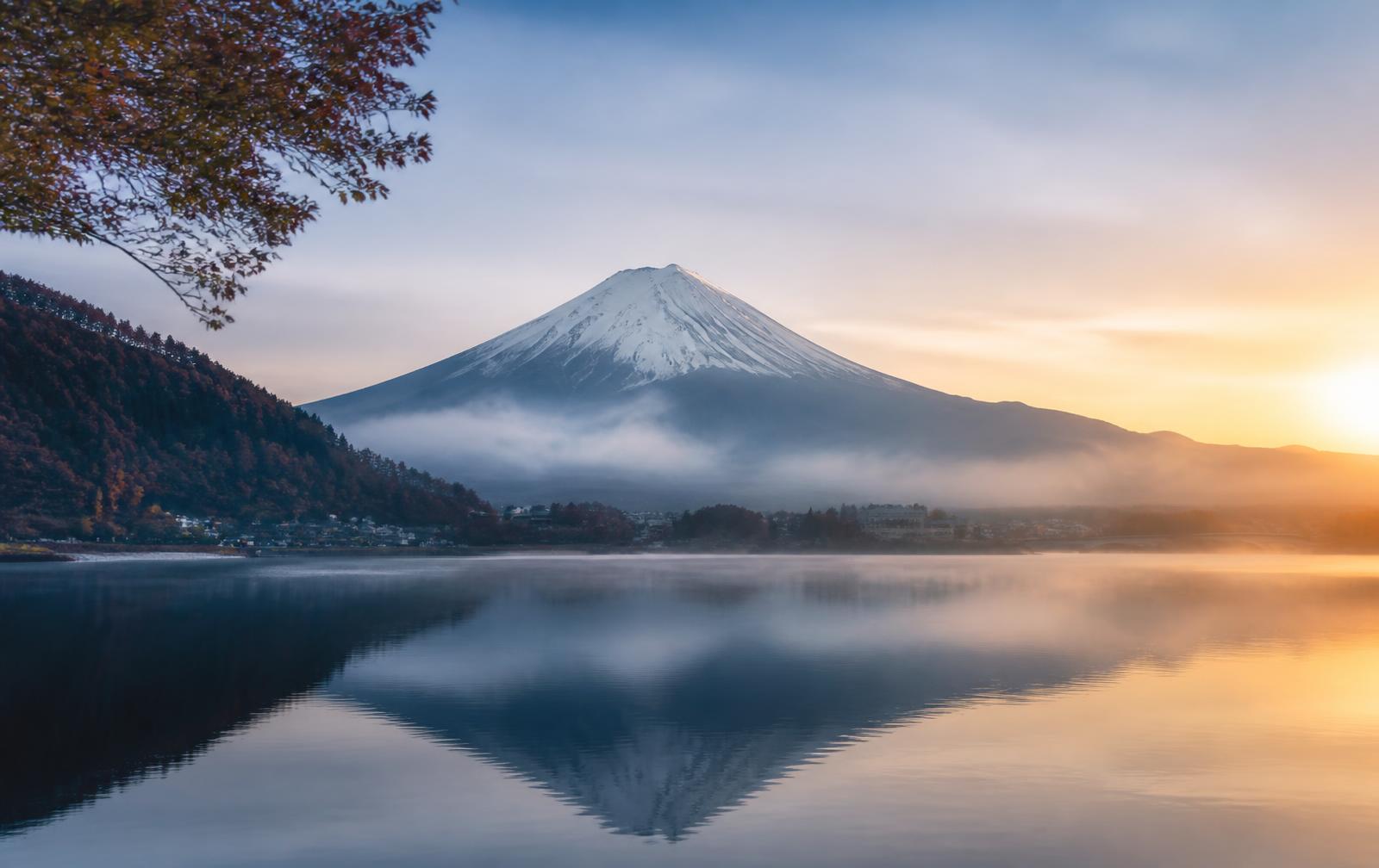Mount Fuji reflected in a still lake at dawn